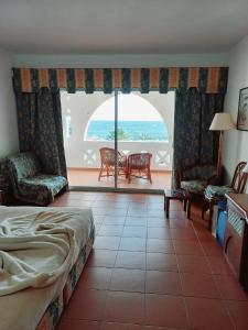 a bedroom with a bed and a view of the ocean at Domina coral bay Sultan - private room in Sharm El Sheikh