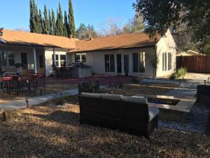 a house with a bench in front of a yard at beautiful house in the hills in Altadena