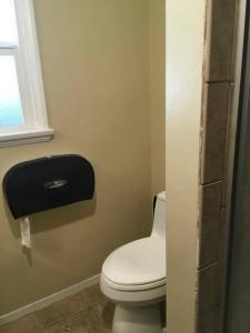 a bathroom with a white toilet and a window at beautiful house in the hills in Altadena