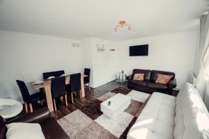 a living room with a couch and a table at Comfy Home-Wood Green in London