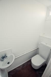 a bathroom with a toilet and a sink at Comfy Home-Wood Green in London