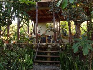 a house with a staircase leading up to a porch at Chalet Ecológico Pantoja in Alto Paraíso de Goiás