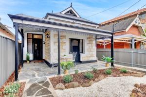 a home with a front porch with a patio at Noir Cottage Glenelg North in Glenelg