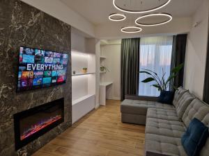 a living room with a couch and a fireplace at Dendrarium Park Apartment Deluxe in Chişinău