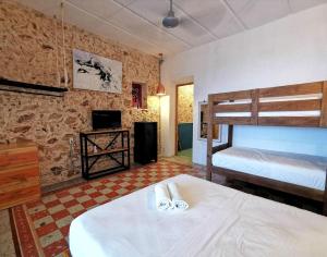 a bedroom with two bunk beds and a television at La 78 alberca y garage con porton electrico in Mérida +32 photos