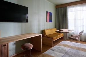 a hotel room with a bed and a chair and a table at River Drive Motel in Venus Bay