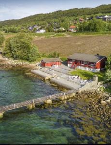 an aerial view of a dock in the water with a building at Strandhytte ved fjorden in Molde