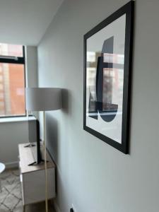 a room with a lamp and a picture on the wall at Fantastic one bedroom apartment near Old Trafford Stadium in Manchester