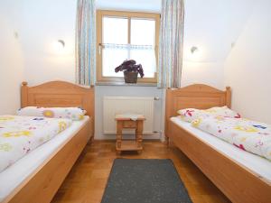 two twin beds in a room with a window at Cozy group house with its own garden and wellness area in Schönsee
