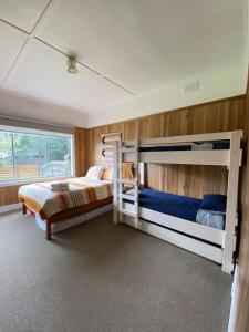 a bedroom with two bunk beds and a window at Family cottage with Spa in Cowes