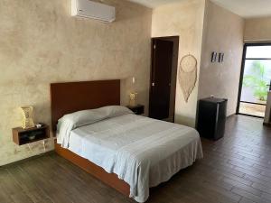 Postel nebo postele na pokoji v ubytování Hotelito YUM KAAX