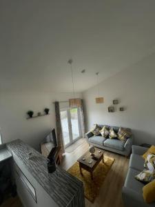 a living room with a couch and a table at Coastal home with lots of space 5 bedrooms. in Buckhaven