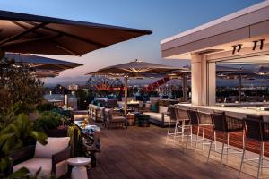 a rooftop patio with tables and chairs and umbrellas at The Westin Anaheim Resort in Anaheim