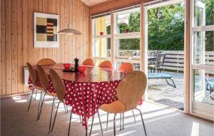 a dining room with a table and chairs at Stunning Home In Aakirkeby With Kitchen in Vester Sømarken