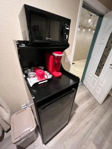 a small black refrigerator with a microwave and red cups at Lantern Light Inn - Romantic Getaway in Sedona +77 photos