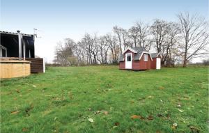 a small house in a field of grass at Four-Bedroom Holiday Home In Brenderup Fyn in Skovs-Højrup