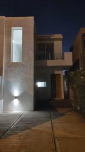 a building with a light on the side of it at Duplex en barrio privado in Mendoza