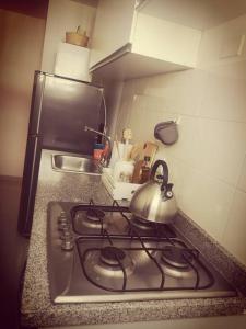 a tea kettle on top of a stove in a kitchen at Moderno, ubicación estratégica. in Bucaramanga