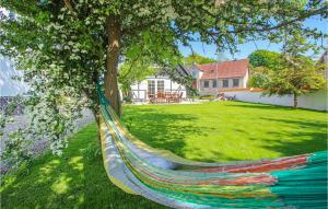 a hammock hanging from a tree in a yard at Awesome Home In Sams With Kitchen in Brundby