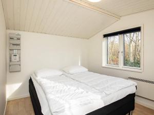 a white bed in a room with a window at 8 person holiday home in Vig-By Traum in Vig