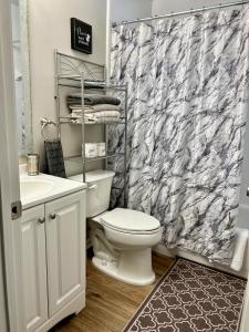 a bathroom with a toilet and a shower curtain at Beautiful Beach house with heated pool in Jacksonville