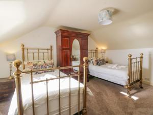 a bedroom with two bunk beds and a mirror at Port Donnel Cottage in Dalbeattie