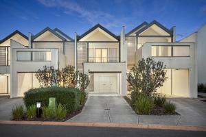 a large house with a driveway in front of it at Quest Sanctuary Lakes in Point Cook