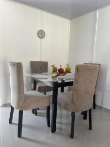 a dining room table with two chairs and a laptop at Apartamento Vacacional Riohacha in Ríohacha