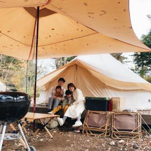 煙神キャンプヴィレッジ في تويوكا: مجموعة من الناس يجلسون في خيمة