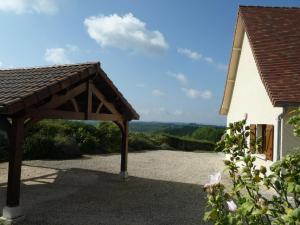 a patio with awning in front of a house at Maison à Salignac-Eyvigues avec terrasse, Wifi et parking - FR-1-616-116 in Salignac Eyvigues