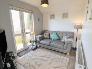 a living room with a couch and a window at Field View in Grimsby