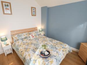 a bedroom with a bed with a bedspread with a christmas decoration at Field View in Grimsby