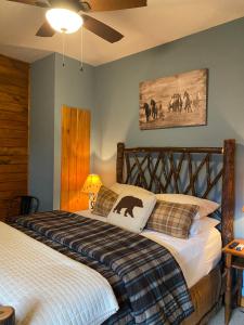 a bedroom with a bed in a room with a horse picture at Letchworth Farm Guesthouses in Nunda