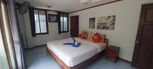 a bedroom with a bed with a blue elephant on it at Kohkaew Village 2@Kohsamet in Ko Samed