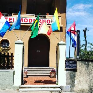 a group of flags on the front of a building at Hotel Moderno in Aritzo