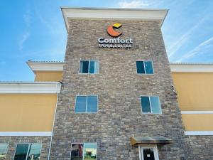 a building with a sign on the side of it at Comfort Inn & Suites Wylie in Wylie