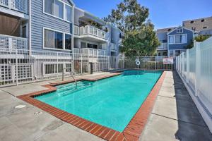 a swimming pool in front of a building at Cozy-Chic Condo Walk to Beach and Park! in Dana Point