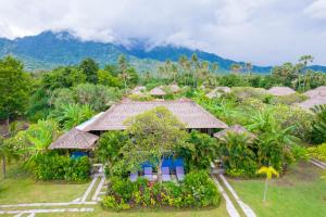 a resort with a mountain in the background at Amertha Bali Villas in Pemuteran