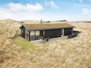 a small house in the middle of a field at 6 person holiday home in Pandrup-By Traum in Pandrup +35 photos