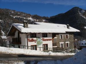 a building with snow on the top of it at Valley Vacanze in Brusson
