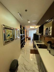 a large kitchen with a counter and a room at Luxurious Family Room Pico de Loro in Nasugbu