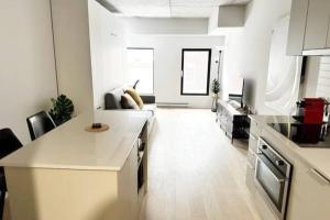 a kitchen with white counters and a living room at 1406 Sainte Elisabeth in Montreal