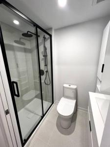 a white bathroom with a shower and a toilet at 1406 Sainte Elisabeth in Montreal