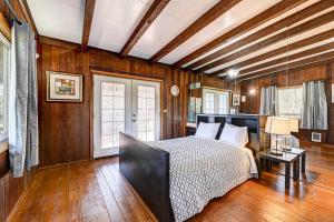 - une chambre avec un lit dans une pièce dotée de murs en bois dans l'établissement Pet-Friendly Grants Pass Home with Hot Tub!, à Grants Pass