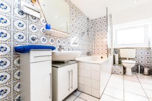 a bathroom with a sink and a toilet at Apartments Bensberg in Bergisch Gladbach +16 photos