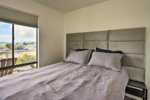 a bedroom with a large bed with a large window at San Francisco Area Studio with Bay Views! in Emeryville