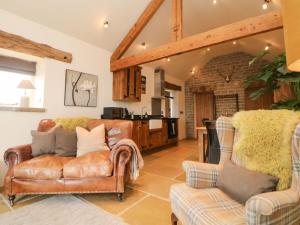 a living room with a couch and two chairs at Five Wells Barn in Flagg