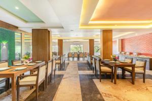 a dining room with wooden tables and chairs at Seasons A Boutique Hotel in Udaipur