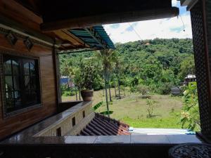 an outside window of a house with a view of a field at Harmony House Stay in Padangbai