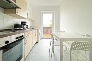 a kitchen with a table and a table and chairs at Chic Apartment in Jüterbog in Jüterbog